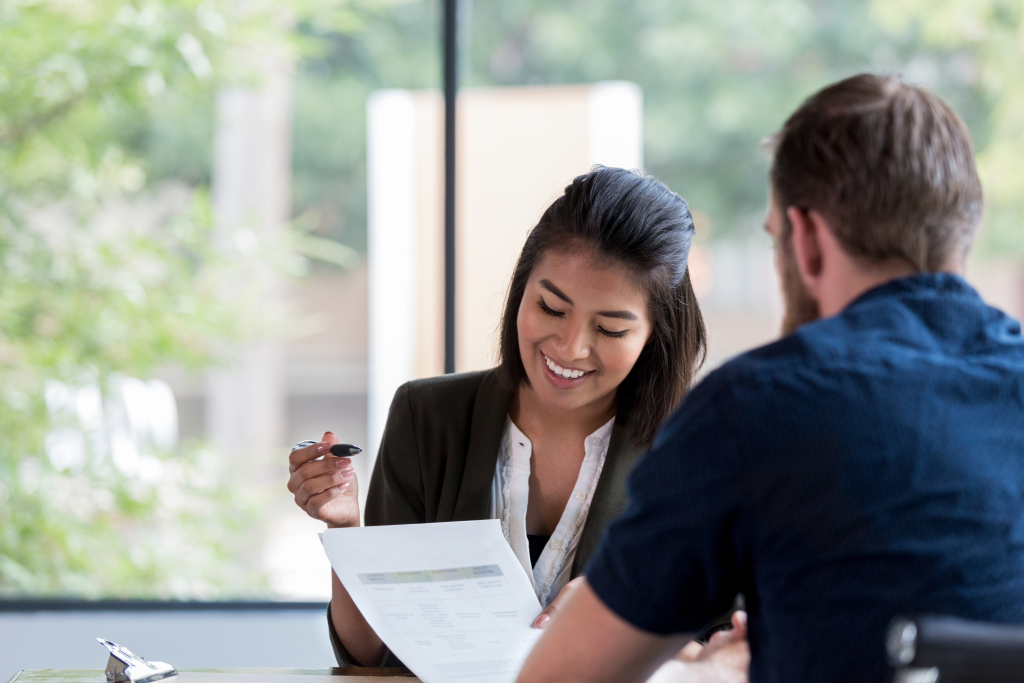 Business lending advisor reviewing finance options with an Australian business owner in a professional consultation setting.