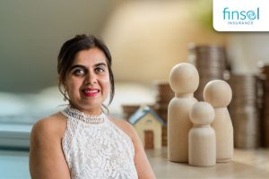 Homeowner reviewing finances after settlement with family model figures and savings in background
